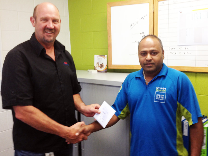 Gary Kirkland-Smith presents Dinesh Prasad with a $200 shopping voucher. 