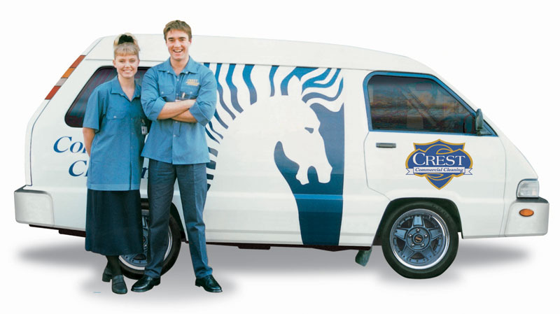 1990s: How we've changed! This promotional photo dating back to the 1990s shows a young couple in CrestClean uniform next to a vehicle displaying an original version of the company logo. 