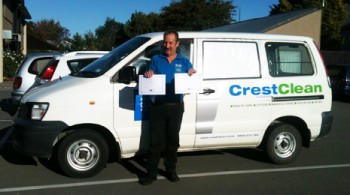 Pictured is Colin Hunt standing with his van holding two of his four Certificates of Excellence's