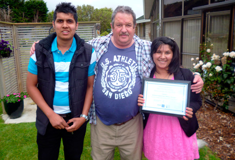 Invercargill Crest Regional Manager Glenn Cockroft presents the certificate for Invercargill's Franchisee of the Year 2013 to Richard Chand and Akhtar Juanmiry at the Christmas Party.
