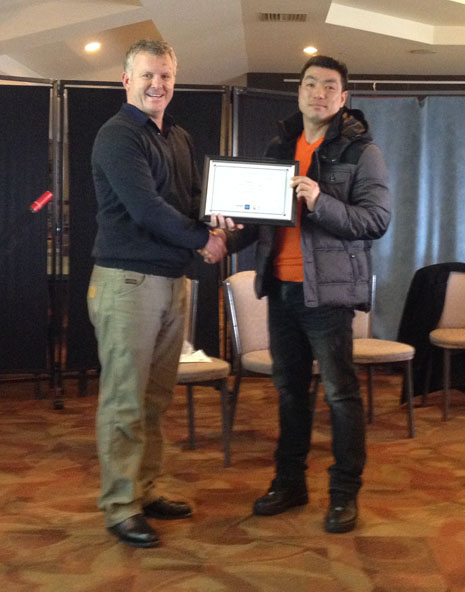 Grant congratulating Michael Choi on 5 years with Crest. 