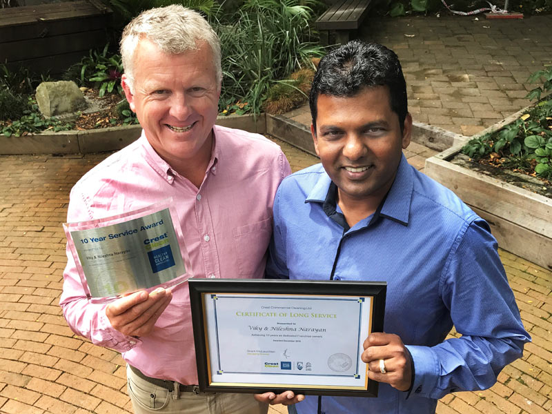 Viky Narayan receives his Long Service Award from Grant McLauchlan.