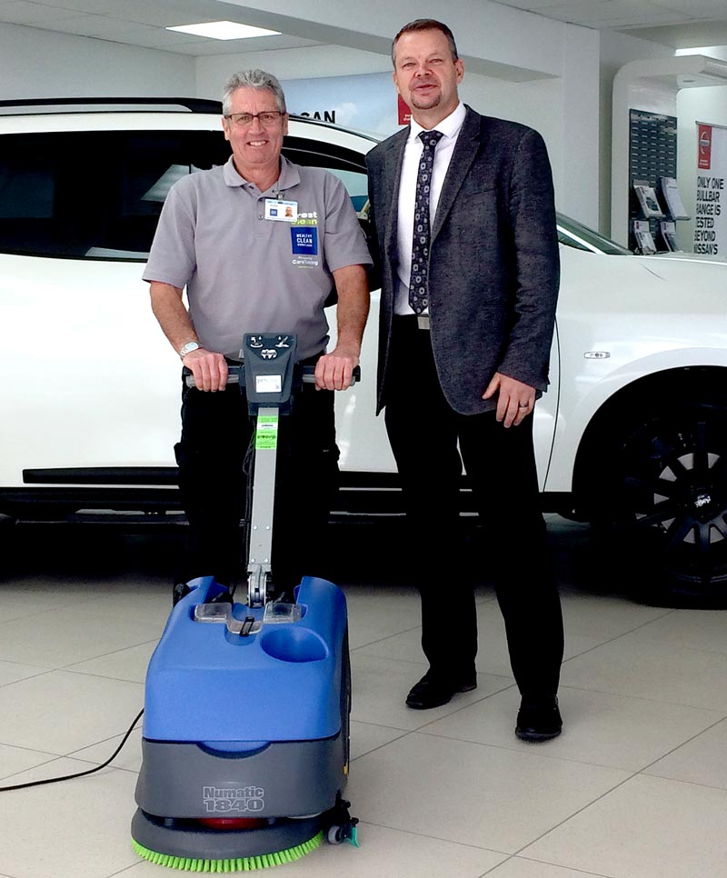 CrestClean franchisee Murray Kelly demonstrates the floor scrubber to Chris Churchward, Dealer Principal, Autoworld Timaru.