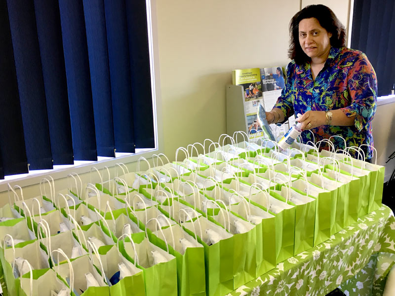Barbara de Vries puts together the gifts for delegates attending the lunch.