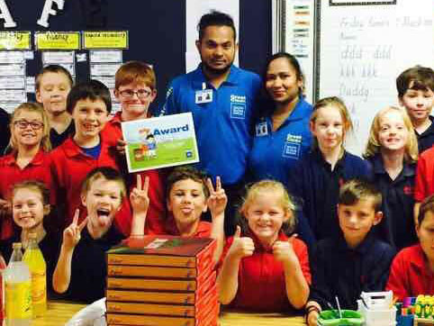 Aznayne Ali and his wife Anjeline Sahayam with kids at Milson School in Palmerston North where they handed out pizza to kids for the Cleanest Classroom Award.