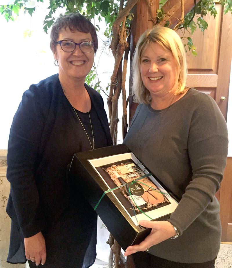 Ngaire Williams, from Glen Eden Primary School, receives a gift hamper from Caroline Wedding, CrestClean’s Auckland West Regional Manager. The prize was for winning a competition draw.
