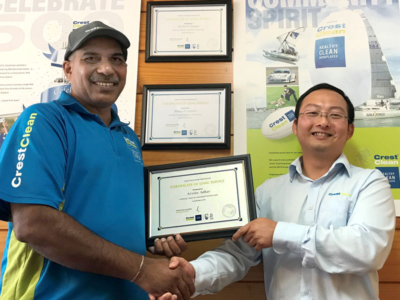 Krishn Adhar receives his long service award from Jason Cheng, a CrestClean Quality Assurance Coordinator for the Waikato.