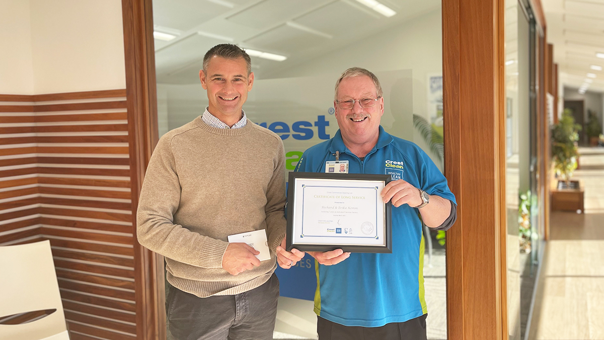 Cleaner presented with long service certificate.