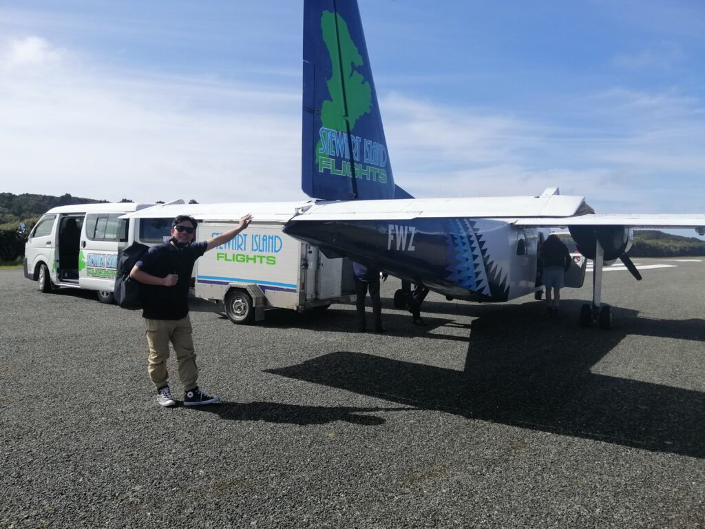 Man standing next to aeroplane.