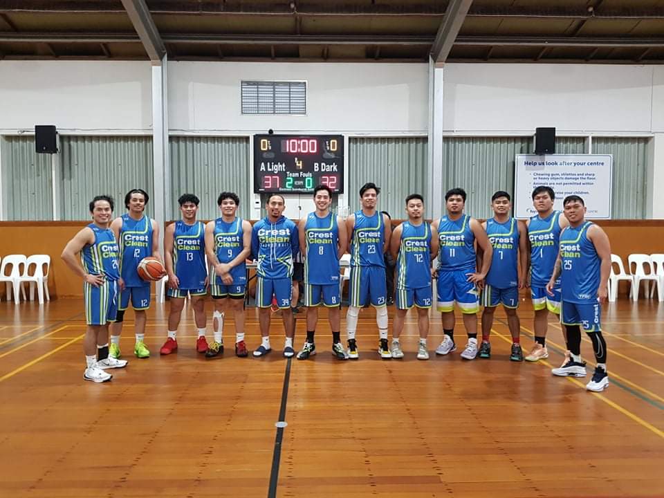 Basketball team standing on court.
